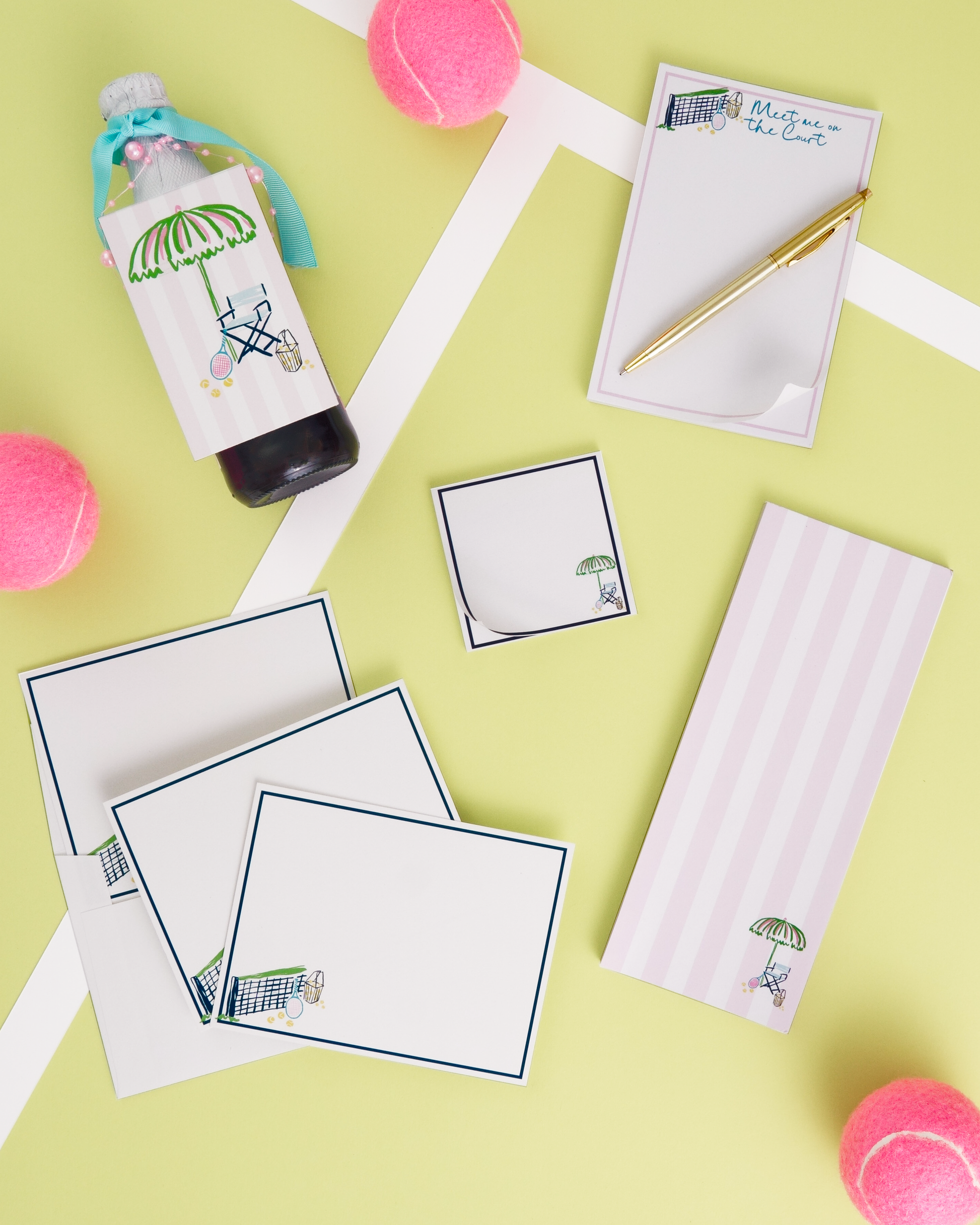 various items, including a bottle, a pen, a notepad, and some pink tennis balls, all arranged on a yellow background.